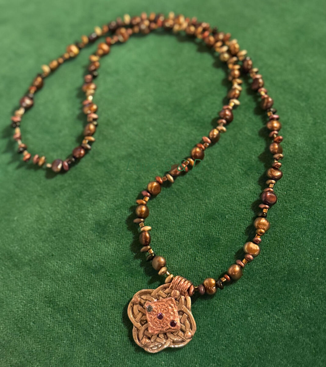 Custom Celtic Pendant for Irish Mother of the Groom in Bronze & Copper. Pendant incorporates birthstones of Son, Bride & Herself strung with pearls in varying shades of gold, bronze & copper.