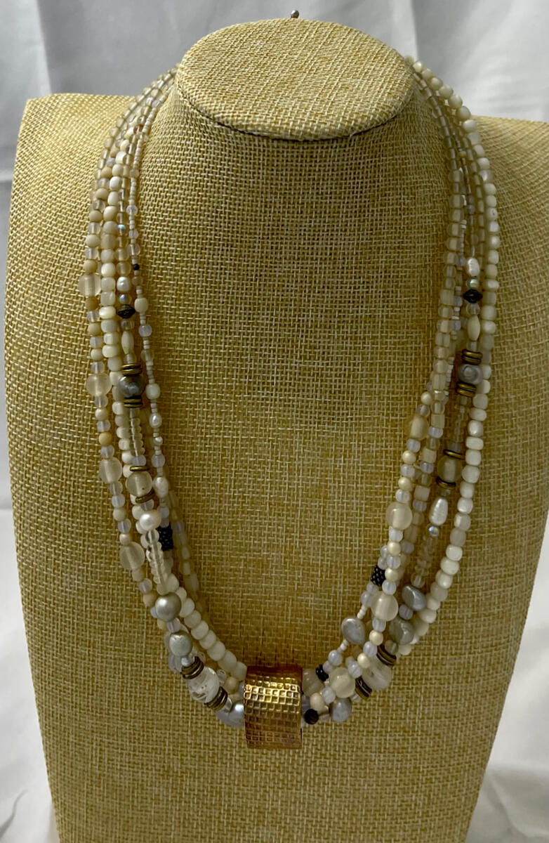 Multi strand pearlized beads with curated gold | bronze ring.